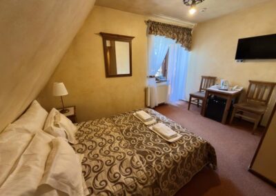 Pokój dwuosobowy z balkonem i łóżkiem małżeńskim